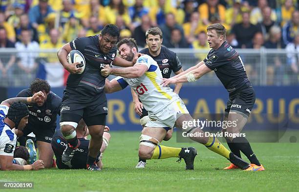 Mako Vunipola of Saracens is tackled by Jamie Cudmore during the European Rugby Champions Cup semi final match between ASM Clermont Auvergne and...