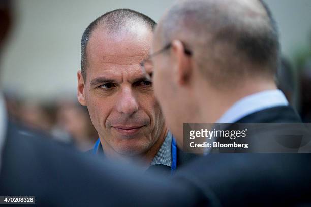 Yanis Varoufakis, Greece's finance minister, left, talks to Kairat Kelimbetov, governor of the National Bank of Kazakhstan, before an IMF governors'...