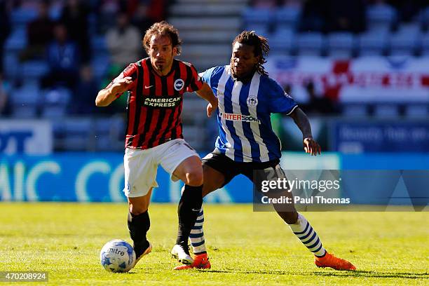 Gaetan Bong of Wigan in action with Inigo Calderon of Brighton during the Sky Bet Championship match between Wigan Athletic and Brighton & Hove...