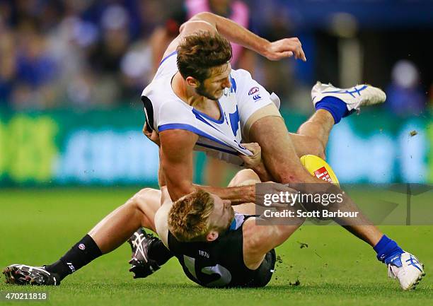 Jarrad Waite of the Kangaroos is tackled by Jackson Trengove of the Power during the round three AFL match between the North Melbourne Kangaroos and...