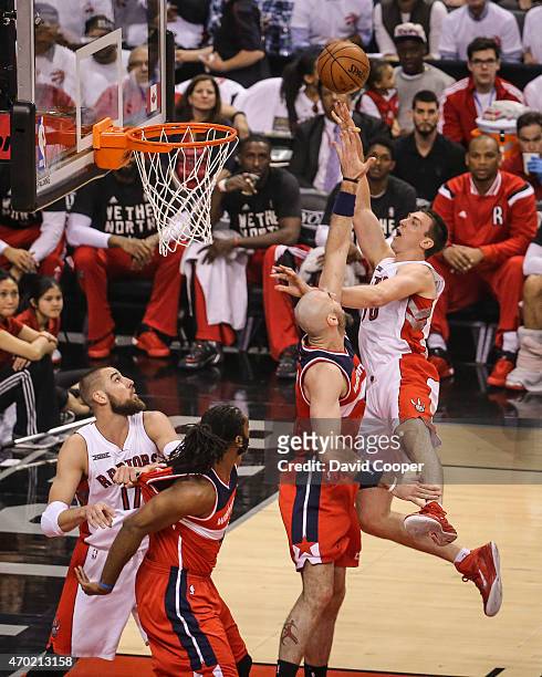Tyler Hansbrough of the Toronto Raptors goes up over Marcin Gortat of the Washington Wizards to the hoop during the game between the Toronto Raptors...