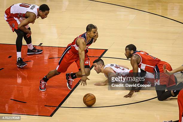 Greivis Vasquez and DeMar DeRozan of the Toronto Raptors loose possession of the ball to Ramon Sessions of the Washington Wizards late in the 2nd...