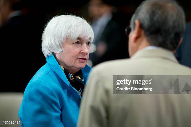 Janet Yellen, chair of the U.S. Federal Reserve, left, talks to Rakesh Mohan, executive director of the International Monetary Fund , during the...