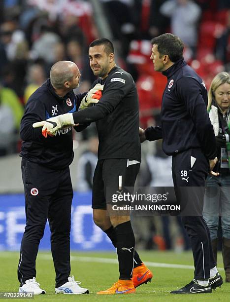 Reading's manager Steve Clark tries to console Reading's Australian goalkeeper Adam Federici after Reading lost 2-1 to Arsenal in the FA Cup...