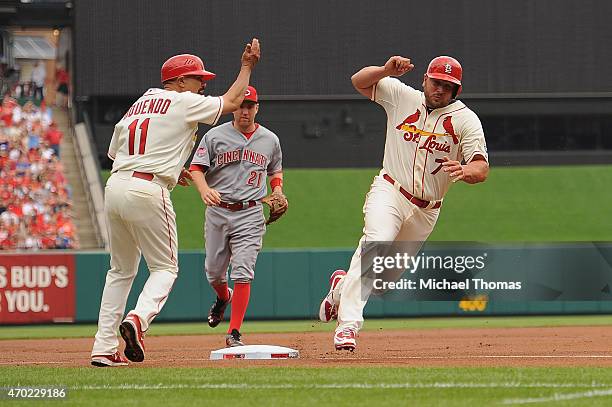 Matt Holliday of the St. Louis Cardinals rounds third base to score in the first inning against the Cincinnati Reds at Busch Stadium on April 18,...