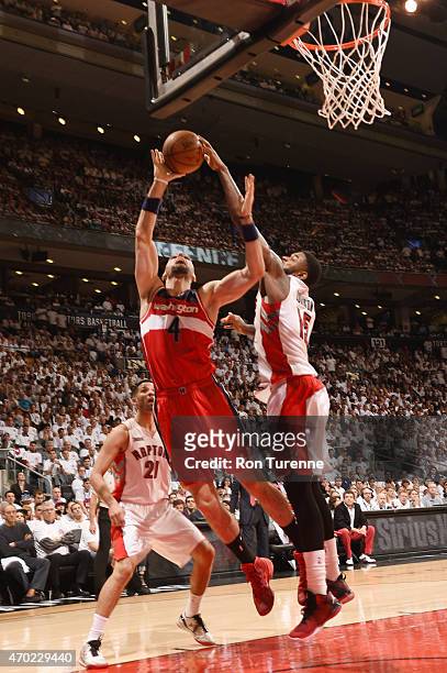 April 18: Marcin Gortat of the Washington Wizards goes for the layup as Amir Johnson of the Toronto Raptors blocks the ball during Game One of the...