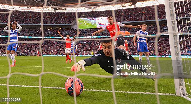 Adam Federici of Reading stretches for the ball as he fails to stop a shot by Alexis Sanchez of Arsenal for their second goal during the FA Cup Semi...