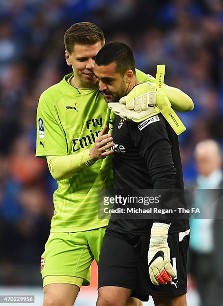 Adam Federici of Reading is consoled by Wojciech Szczesny of Arsenal after the team lost the FA Cup Semi-Final match between Arsenal and Reading at...