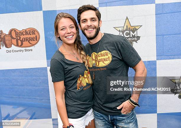 Lauren Akins and singer-songwriter Thomas Rhett attend the Cracker Barrel Old Country Store Country Checkers Challenge at Globe Life Park in...