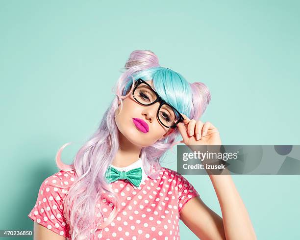 pink hair manga style girl holding nerd glasses - funky stockfoto's en -beelden