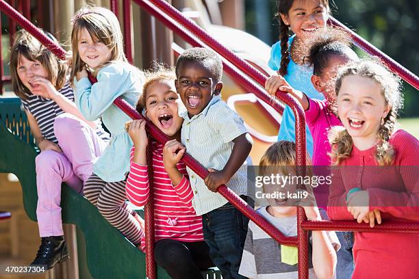 big group of multi-ethnic children on a sunny playground - playground stock pictures, royalty-free photos & images