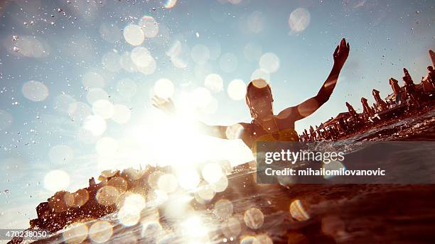 young woman having fun - jumping into water stock pictures, royalty-free photos & images