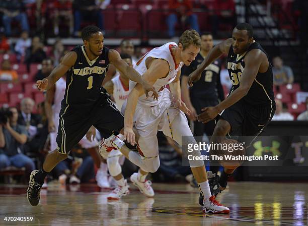 Maryland Terrapins guard/forward Jake Layman battles for a loose ball with Wake Forest Demon Deacons guard Madison Jones and Wake Forest Demon...