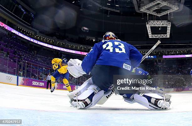 Loui Eriksson of Sweden shoots and scores against Robert Kristan of Slovenia in the third period during the Men's Ice Hockey Quarterfinal Playoff on...