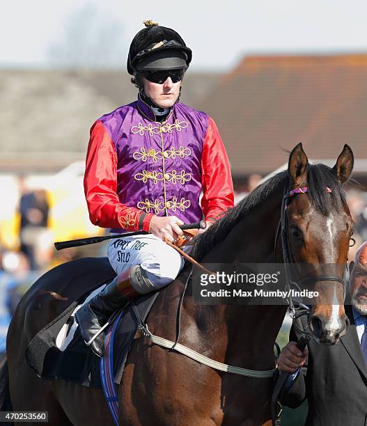 Jockey Tom Queally rides Queen Elizabeth's horse 'Fabricate' at the Dubai Duty Free Spring Trials Meeting at Newbury Racecourse on April 18, 2015 in...