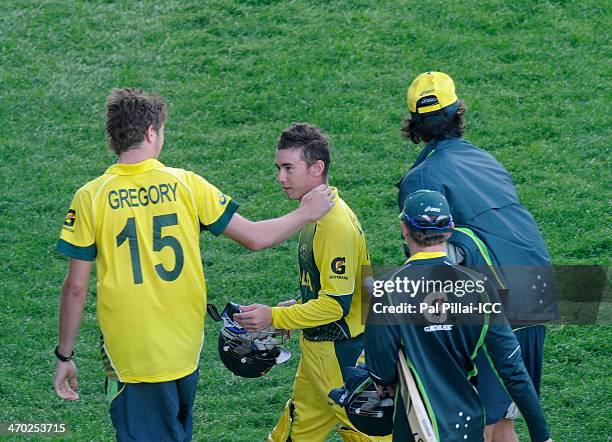 Team captain Alex Gregory congratulates teammate Jake Doran of Australia as he walks back after the innings during the ICC - U19 CWC match between...