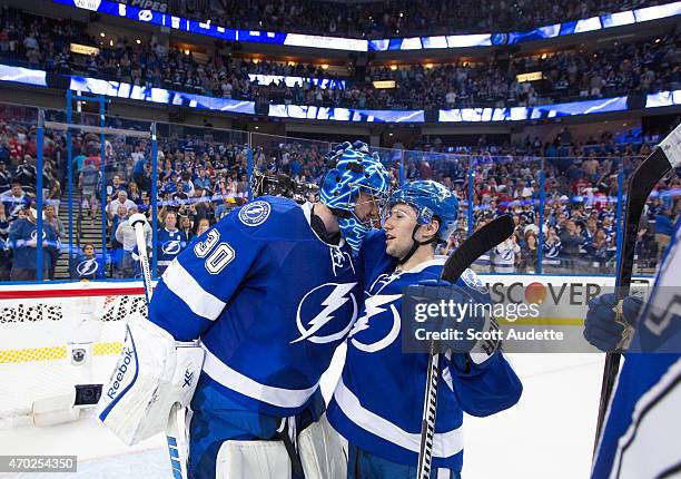 Goalie Ben Bishop and Tyler Johnson of the Tampa Bay Lightning celebrate the win against the Detroit Red Wings during Game Two of the Eastern...