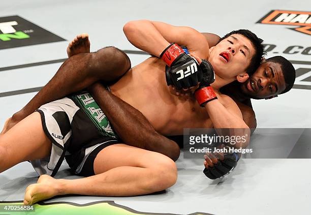 Takeya Mizugaki of Japan and Aljamain Sterling grapple in their bantamweight bout during the UFC Fight Night event at Prudential Center on April 18,...