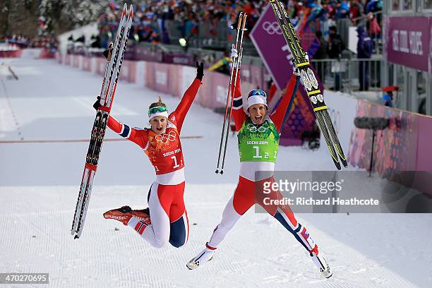 Gold medalists Marit Bjoergen of Norway and Ingvild Flugstad Oestberg of Norway celebrate after the Women's Team Sprint Classic Final during day 12...