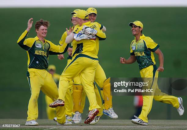 Team mates congratulate Jaron Morgan of Australia as he gets Shadman Islam of Bangladesh run out during the ICC U19 Cricket World Cup 2014 match...