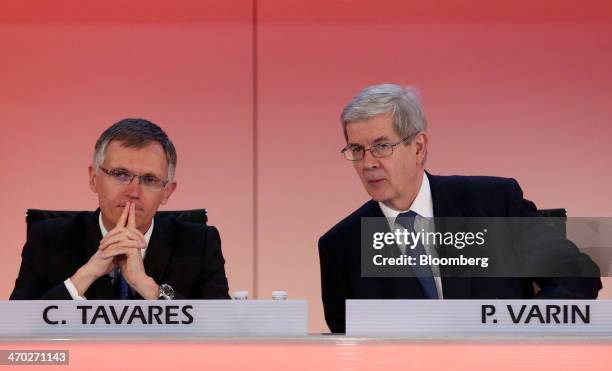 Carlos Tavares, incoming chief executive officer of PSA Peugeot Citroen, left, gestures as he sits with Philippe Varin, outgoing chief executive...