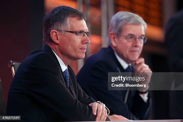 Carlos Tavares, incoming chief executive officer of PSA Peugeot Citroen, left, sits with Philippe Varin, outgoing chief executive officer of PSA...