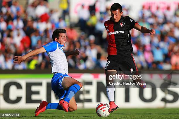 Daniel Alvarez of Atlas struggles for the ball with Facundo Erpen of Puebla during a match between Puebla and Atlas as part of 14th round Clausura...