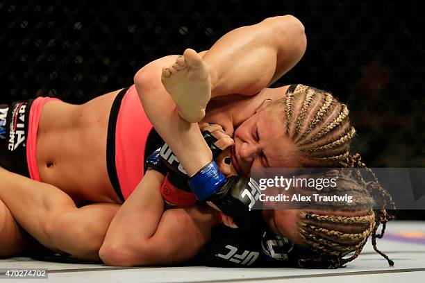 Felice Herrig and Paige VanZant grapple in their women's strawweight bout during the UFC Fight Night event at Prudential Center on April 18, 2015 in...