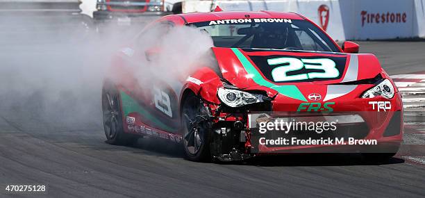 Professional race car driver Antron Brown drives his car on the race track after wrecking during the 38th Annual Toyota Pro/Celebrity Race at the...