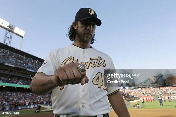 Madison Bumgarner of the San Francisco Giants displays his World Series ring during the San Francisco Giants 2014 World Series Ring ceremony before...