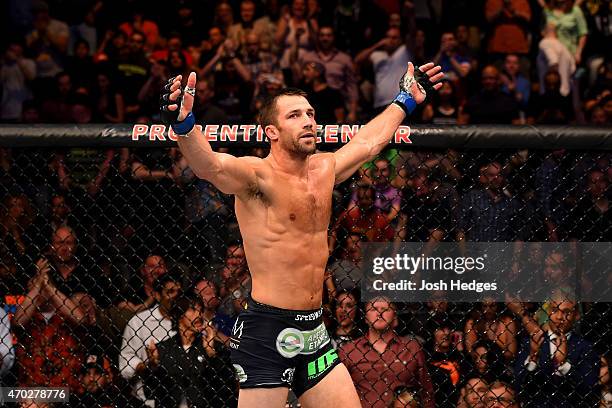 Luke Rockhold celebrates defeating Lyoto Machida of Brazil by tap out in their middleweight bout during the UFC Fight Night event at Prudential...