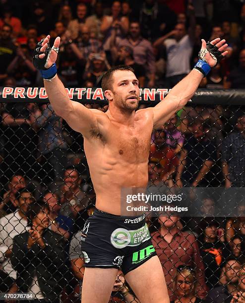 Luke Rockhold celebrates defeating Lyoto Machida of Brazil by tap out in their middleweight bout during the UFC Fight Night event at Prudential...