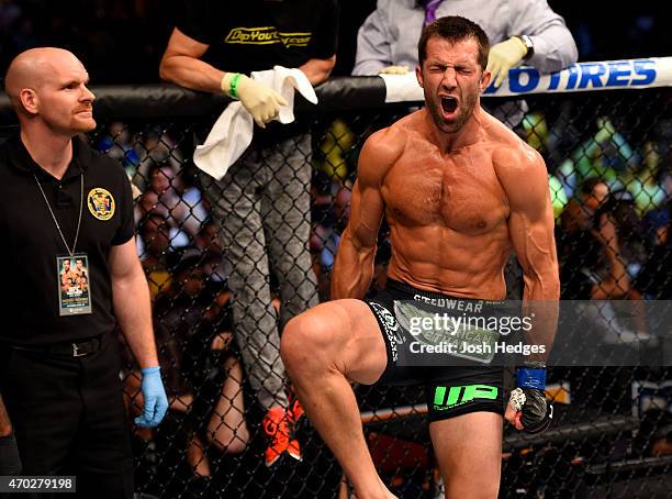 Luke Rockhold celebrates defeating Lyoto Machida of Brazil by tap out in their middleweight bout during the UFC Fight Night event at Prudential...