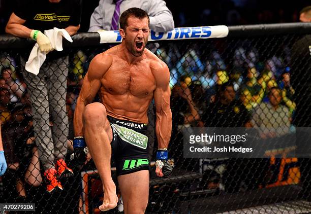Luke Rockhold celebrates defeating Lyoto Machida of Brazil by tap out in their middleweight bout during the UFC Fight Night event at Prudential...