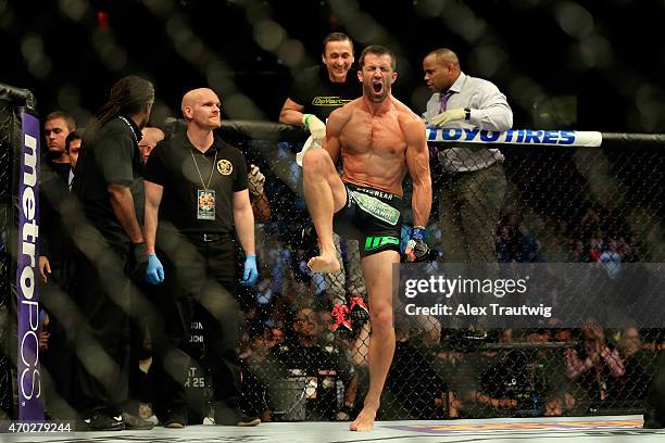 Luke Rockhold celebrates defeating Lyoto Machida of Brazil by tap out in their middleweight bout during the UFC Fight Night event at Prudential...