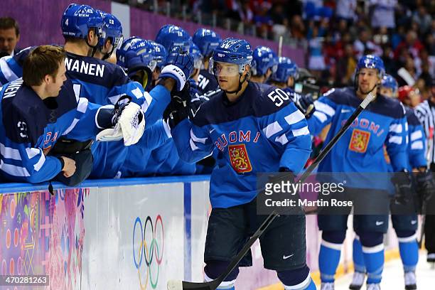 Juhamatti Aaltonen of Finland celebrates with the bench after scoring a first-period goal against Russia during the Men's Ice Hockey Quarterfinal...