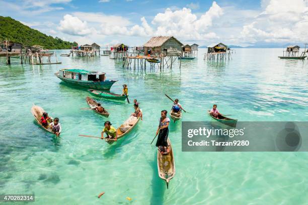 children on boat above clear sea water, malaysia - sabah state stock pictures, royalty-free photos & images