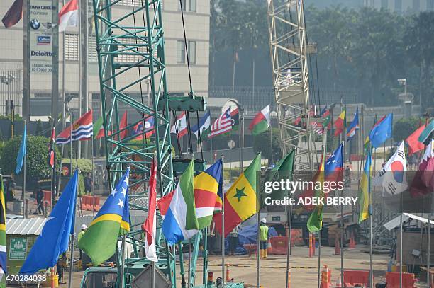 Flags from Asian and African countries are seen near the MRT project ahead of the Asia Africa Conference and World Economic Forum in Jakarta on April...