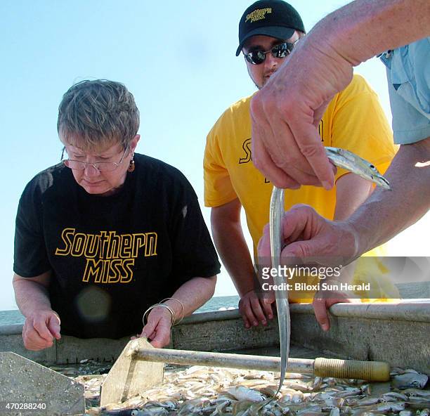 In a May 5 file image, researchers from the University of Southern Mississippi's Gulf Coast Research Lab examine a cutlass found in the deep waters...