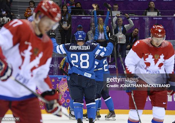 Finland's players celebrate after their teammate Juhamatti Aaltonen scored during the Men's Ice Hockey Play-offs Quarterfinals match between Finland...