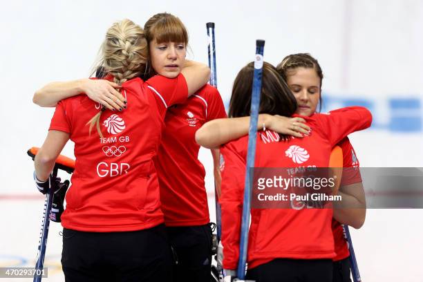 Eve Muirhead, Anna Sloan, Vicki Adams, and Claire Hamilton of Great Britain console each other after losing to Canada during the women's semifinal...