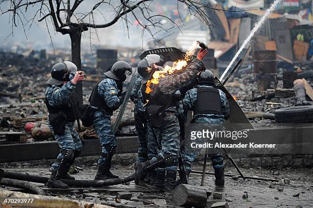 Berkut special forces of the Ukrainian police throw a Molotov cocktail during clashes with Anti-government protesters on Independence Square in Kiev...