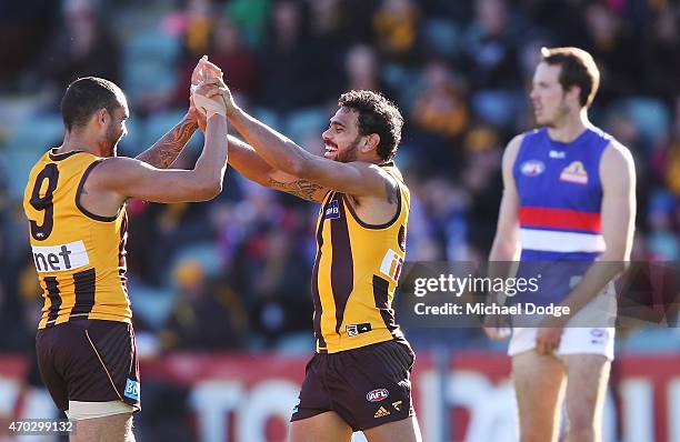 Cyril Rioli of the Hawks celebrates a goal with Shaun Burgoyne during the round three AFL match between the Hawthorn Hawks and the Western Bulldogs...