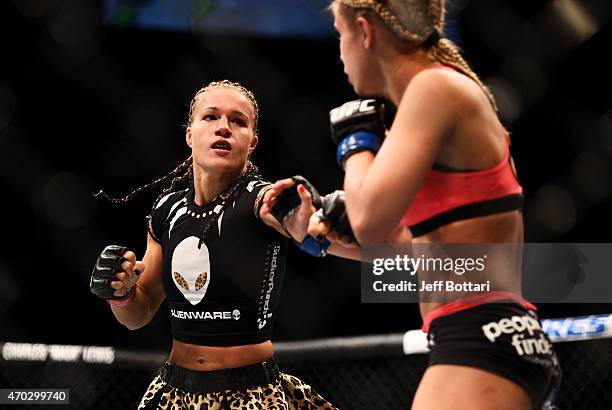 Felice Herrig exchanges blows with Paige VanZant in their women's strawweight bout during the UFC Fight Night event at Prudential Center on April 18,...