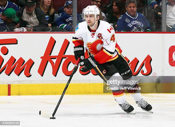 Kris Russell of the Calgary Flames skates up ice with the puck during Game Two of the Western Conference Quarterfinals against the Vancouver Canucks...