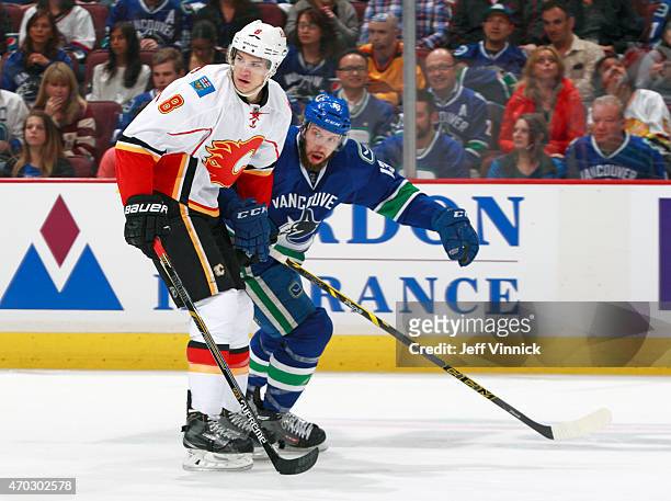 Nick Bonino of the Vancouver Canucks and Joe Colborne of the Calgary Flames skate up ice during Game Two of the Western Conference Quarterfinals...