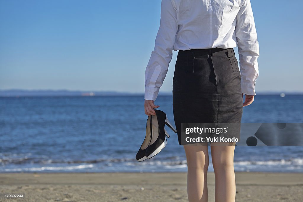 A woman standing on the beach.