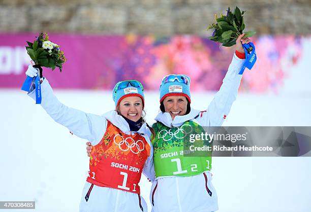 Gold medalists Marit Bjoergen of Norway and Ingvild Flugstad Oestberg of Norway celebrate during the flower ceremony for the Women's Team Sprint...