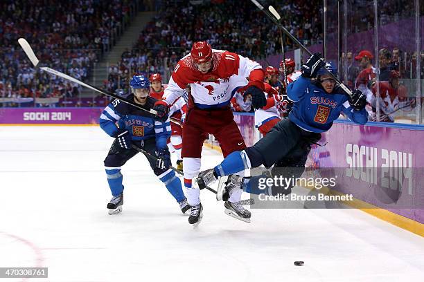 Yevgeni Malkin of Russia knocks Sami Vatanen of Finland into the boards during the Men's Ice Hockey Quarterfinal Playoff on Day 12 of the 2014 Sochi...