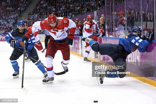 Yevgeni Malkin of Russia knocks Sami Vatanen of Finland into the boards during the Men's Ice Hockey Quarterfinal Playoff on Day 12 of the 2014 Sochi...